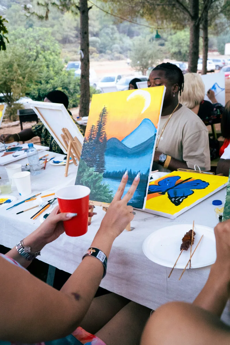 A colorful mountain landscape on canvas at an outdoor painting gathering